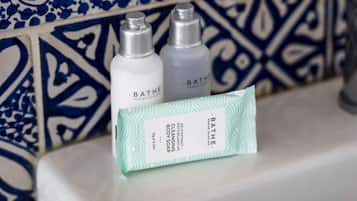 Two bottles of Bathé Marine Skincare products and a box of Bathé Marine Skincare Cleansing Body Soap on a bathroom counter.