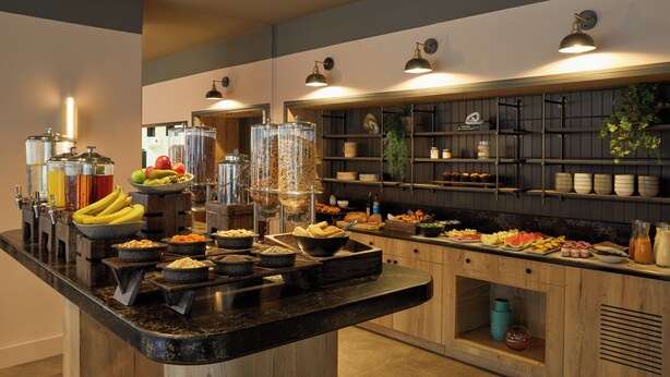 A buffet setup with various food items and beverages.