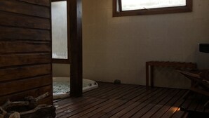 A wooden deck with a hot tub, a bench, and a skylight. - Hosteria Hueney Ruca (San Martín de los Andes)