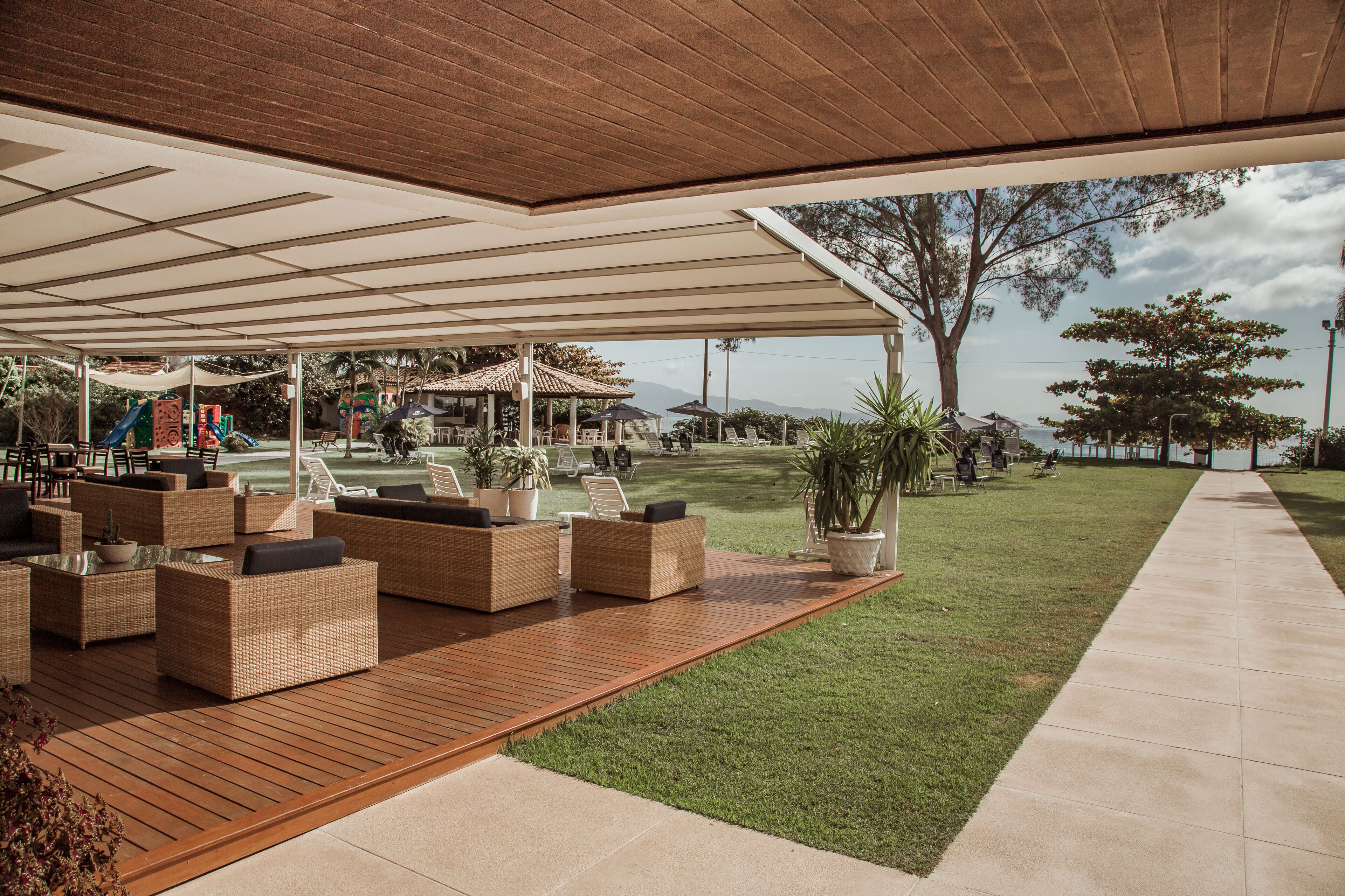 An outdoor seating area with wicker furniture and a covered patio.