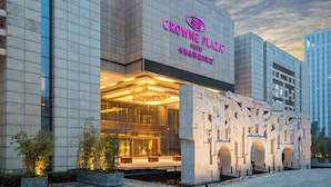 A modern hotel with a prominent entrance, large windows, and a well-lit facade.