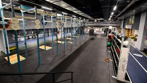 A gym with weightlifting equipment, including a squat rack and benches. - Grand Hotel Italia (Cluj-Napoca)