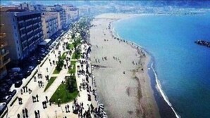 A coastal cityscape with a wide promenade, a beach, and a calm sea. - Villa Rocla Guest House Pompei (Pompei)