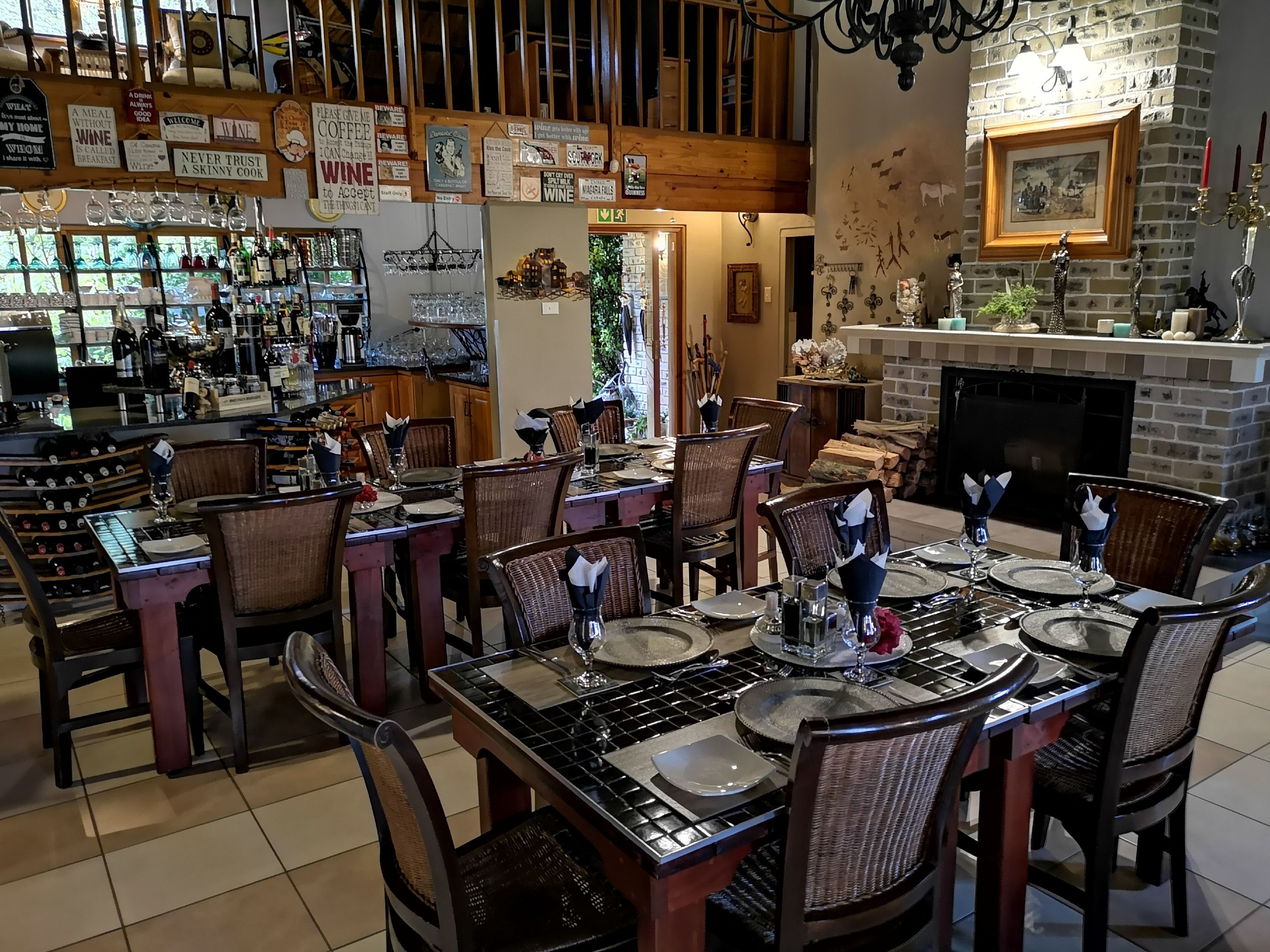 A restaurant with a bar area, wooden furniture, and a fireplace.