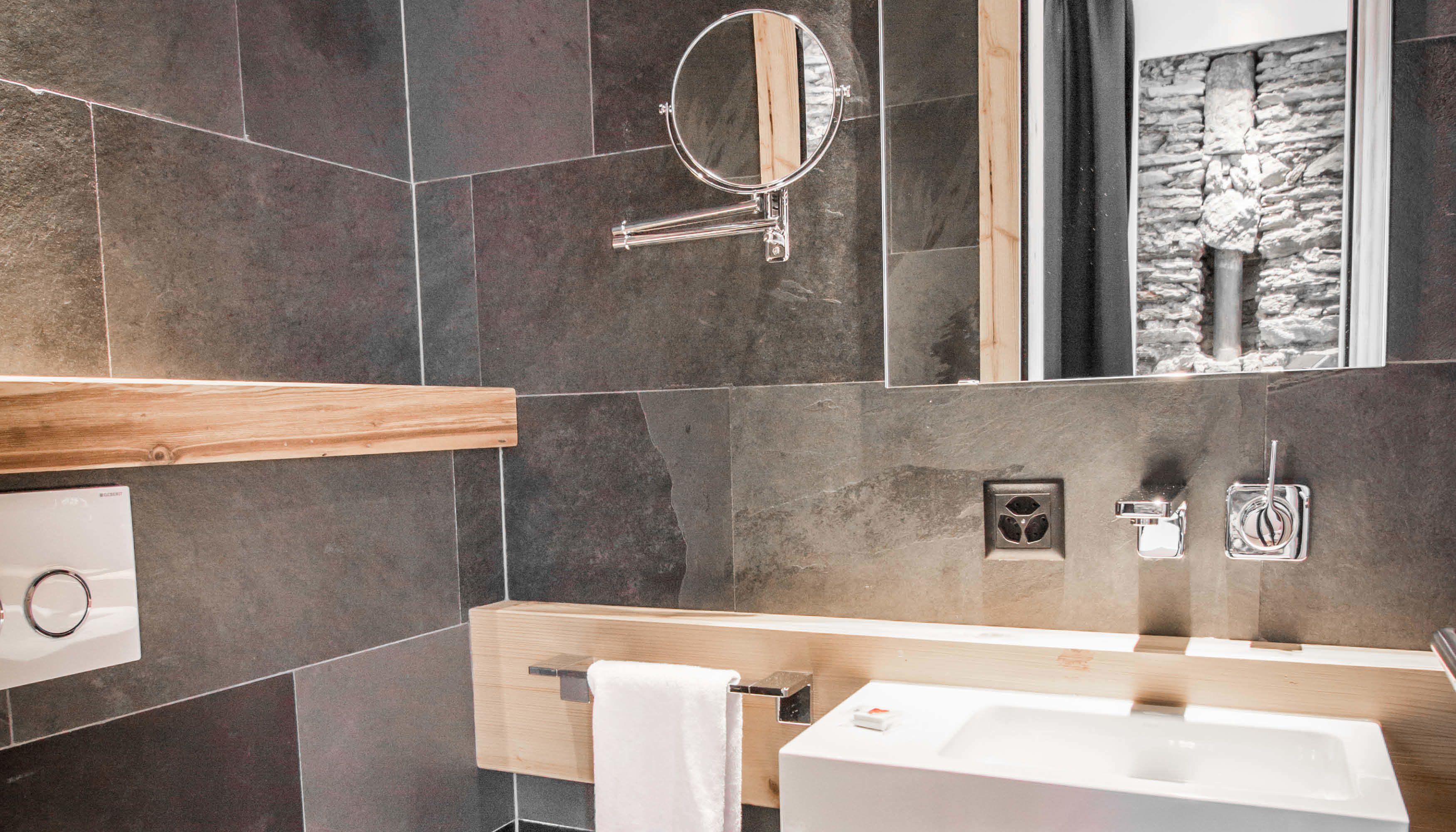 deluxe double room | bathroom | rainfall showerhead, designer toiletries, hair dryer, bathrobes