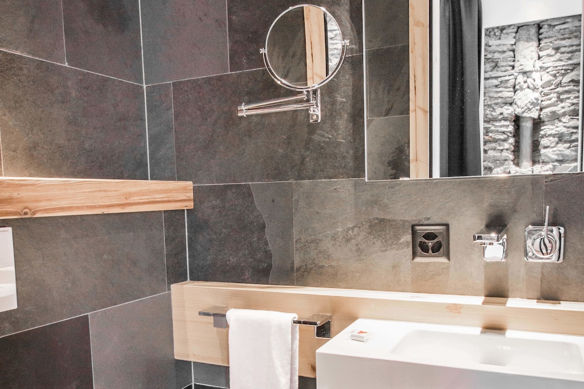 deluxe double room | bathroom | rainfall showerhead, designer toiletries, hair dryer, bathrobes