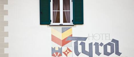 A wall with a window and a geometric design.