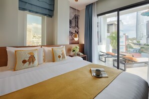 A hotel room with a large bed, a view of the city, and a balcony with seating. - Little Saigon Boutique Hotel (Ho Chi Minh City)