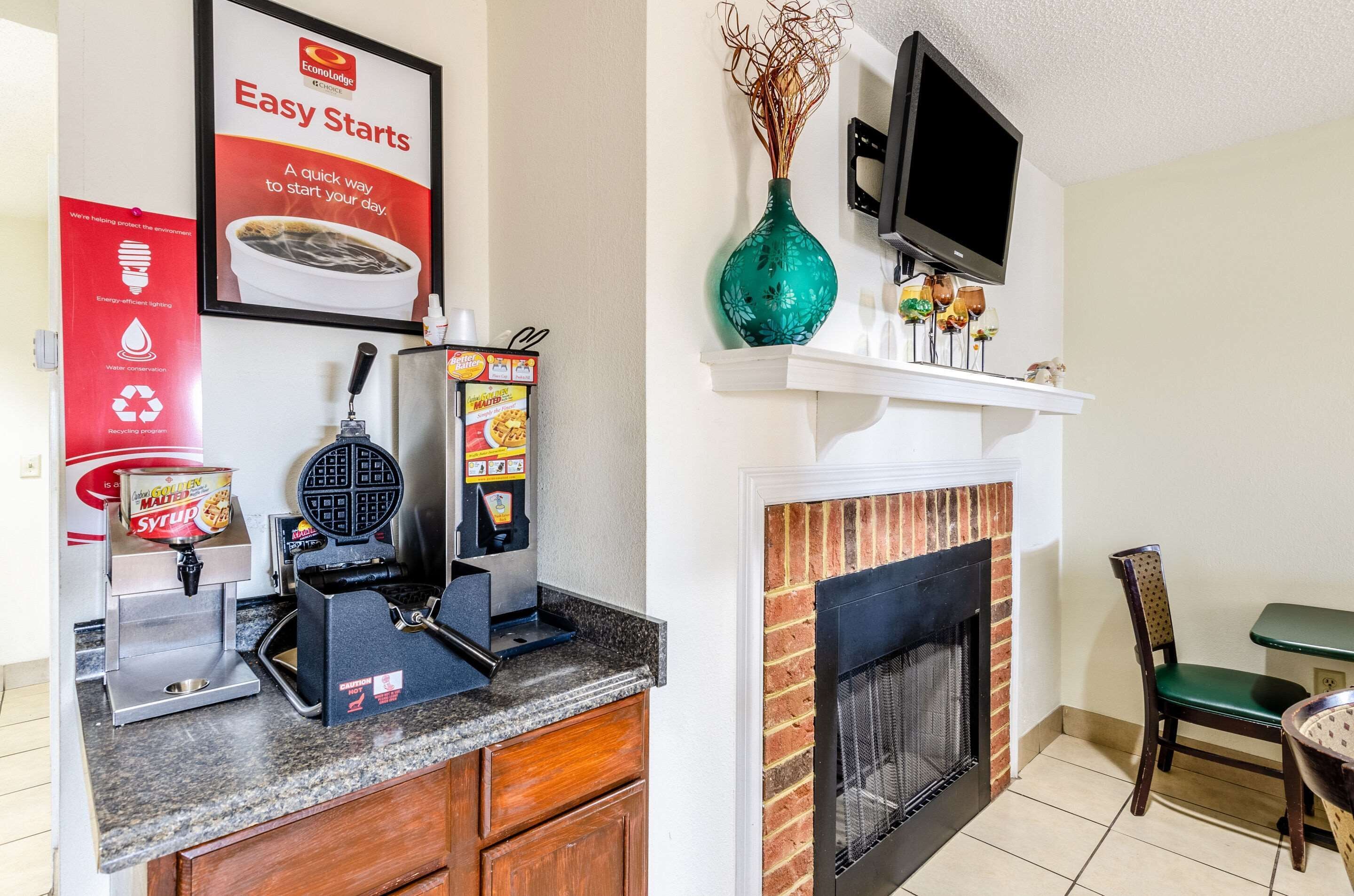 A kitchen with a waffle maker, a coffee machine, and a sign for Easy Starts.