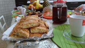 A kitchen with a table set for breakfast, including pastries, fruits, and a beverage. - B&B Raggio di Sole (Trevignano Romano)
