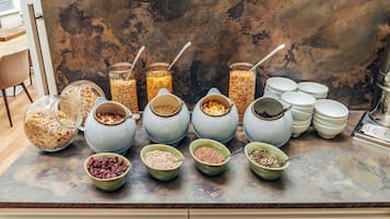 A breakfast buffet with various food items and containers.
