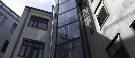 A multi-story building with a modern architectural design, featuring large windows and a glass facade.