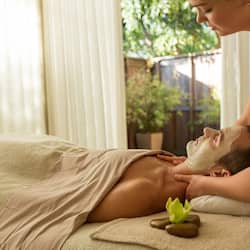 Experience a rejuvenating facial treatment in a serene spa setting, complete with a soothing ambiance and expert care.