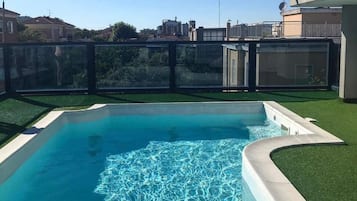 Seasonal outdoor pool, open 9:00 AM to noon, pool umbrellas