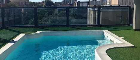 Seasonal outdoor pool, open 9:00 AM to noon, pool umbrellas