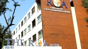 A hotel sign with "The ROA" and "A Brand of GkSa Numerrus Group" written on it. - The Roa (Mumbai)