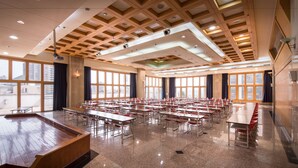 A spacious conference room with a long table and chairs, large windows, and a wooden ceiling. - Formosa Corridor Hotel (Taichung)