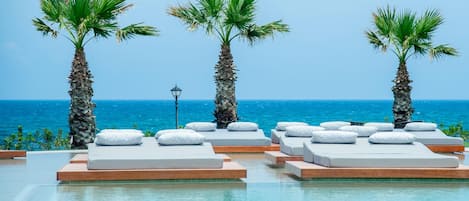 Outdoor pool, open 10:00 AM to 6:00 PM, pool umbrellas, pool loungers