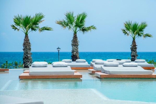 Outdoor pool, open 10:00 AM to 6:00 PM, pool umbrellas, pool loungers