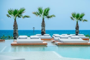 Outdoor pool, open 10:00 AM to 6:00 PM, pool umbrellas, pool loungers