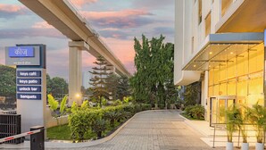 A hotel entrance with a signboard listing amenities like keys cafe, keys patio, unlock bar, and banquets. - Keys Prima by Lemon Tree Hotels, Pimpri Pune (Pune)