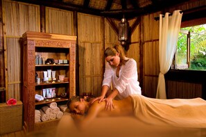 A wooden room with a massage table, a shelf with toiletries, and a hanging lantern. - Lakaz Chamarel Exclusive Lodge (Chamarel)