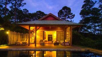 A house with a covered porch and a pool.