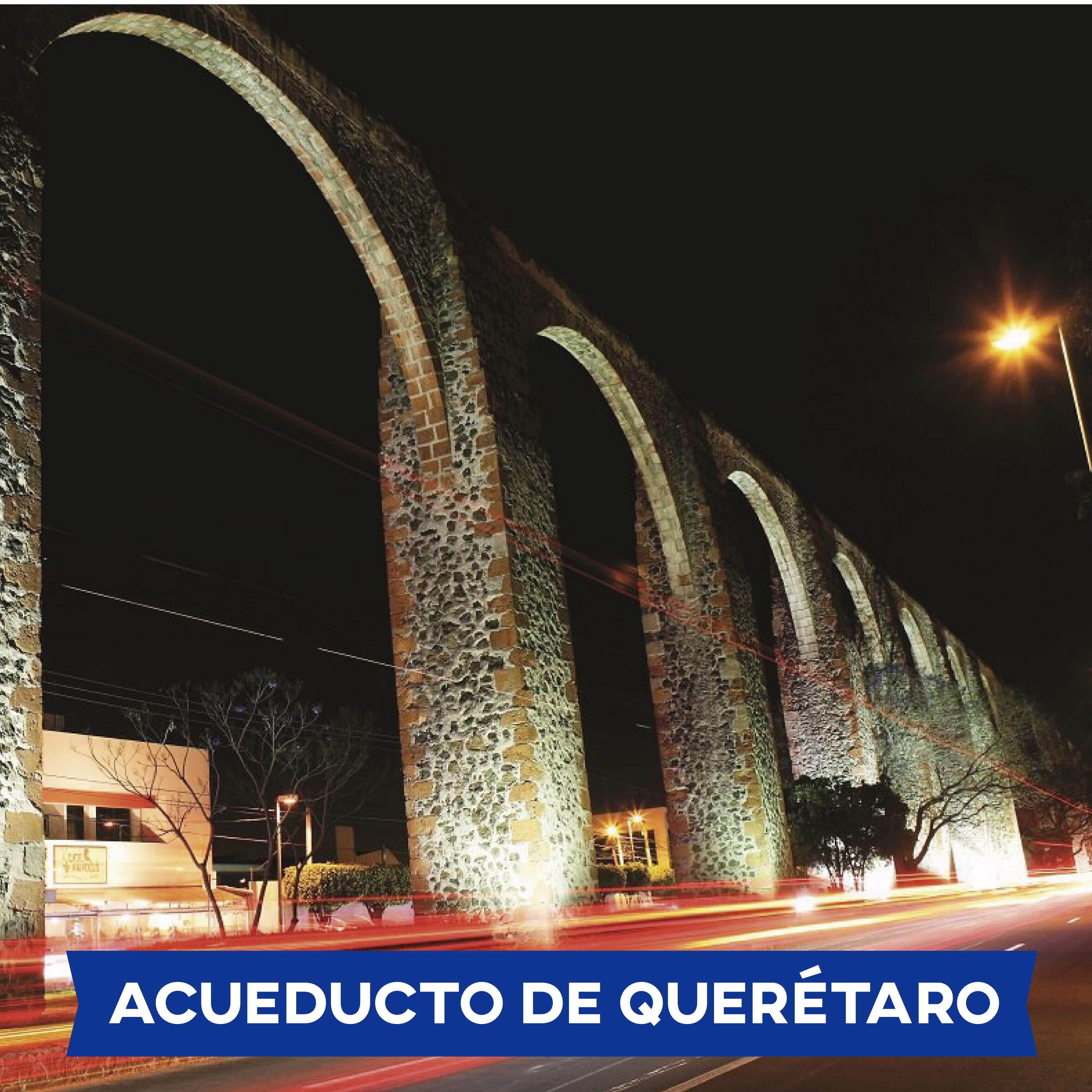 A series of illuminated arches at night.