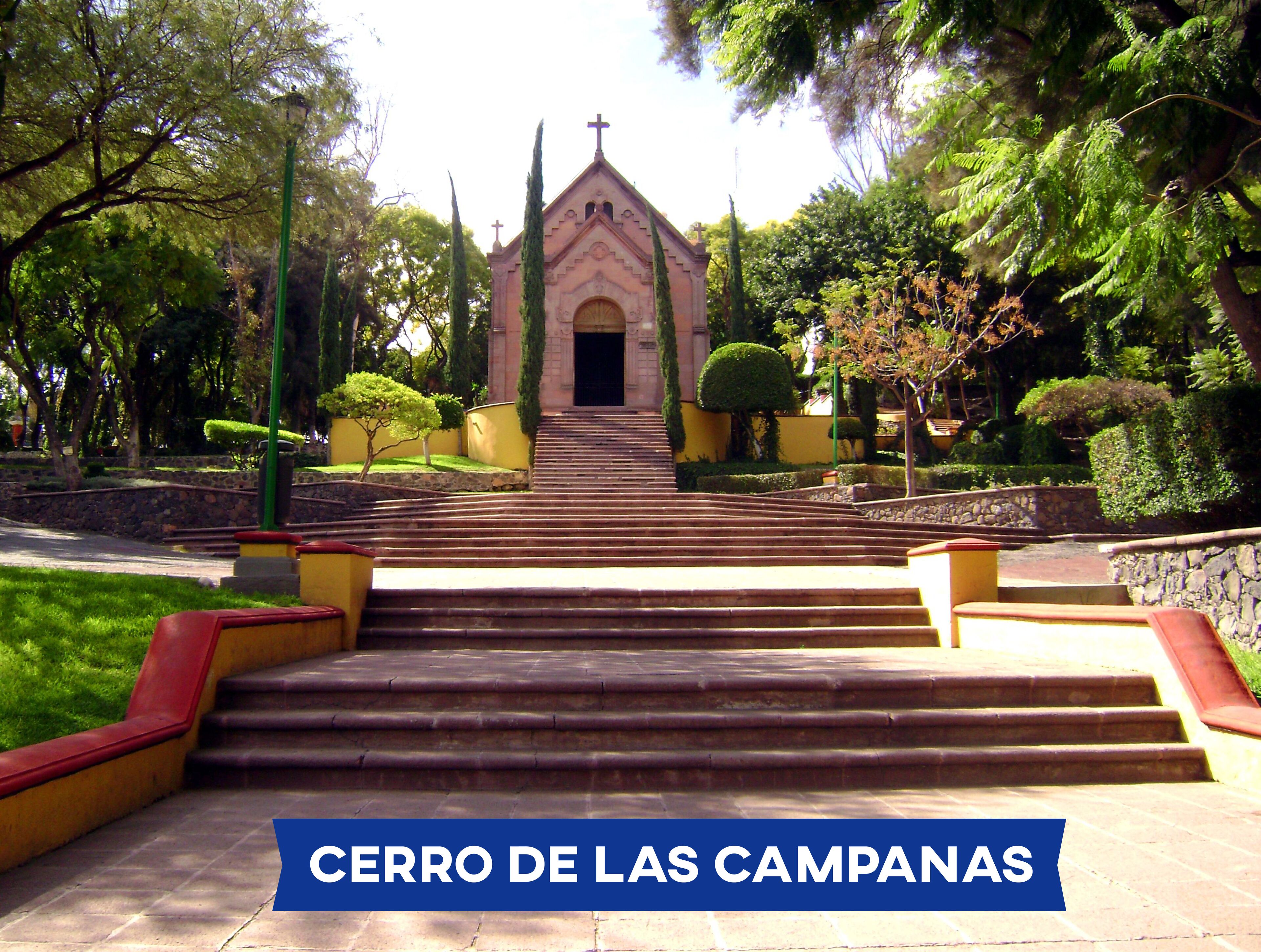 A church with a cross at the top, surrounded by trees and a well-maintained garden.
