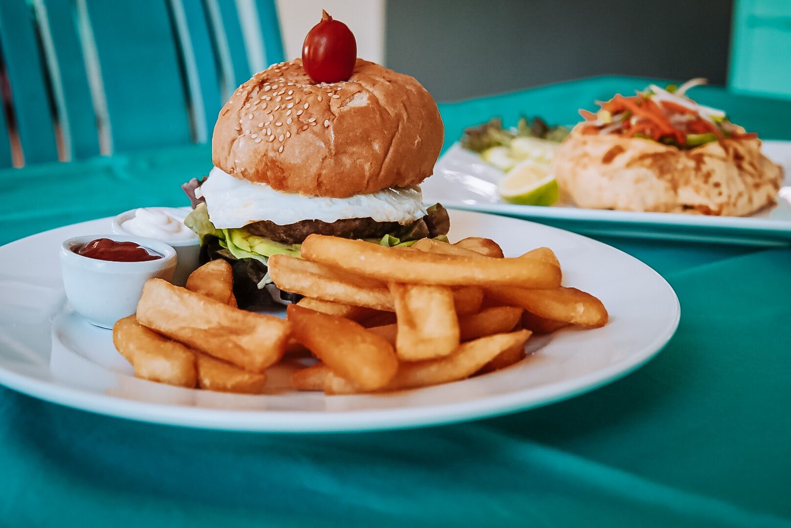 A plate with a burger, fries, and a salad.