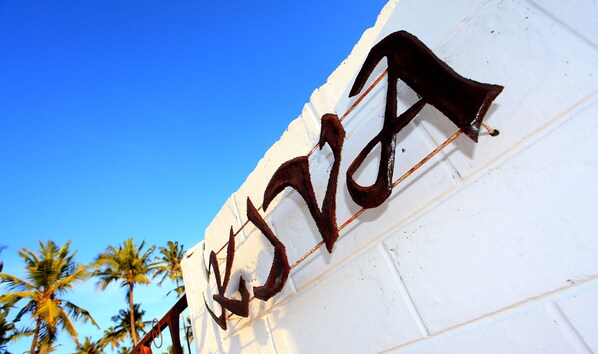 A white building with a sign that reads "JIVA" in a decorative script.