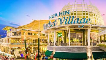 A multi-level shopping mall with a prominent sign reading "HUA HIN Market Village."