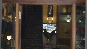 A hotel entrance with a staircase leading to the upper floor. - Hotel Touring (Messina)