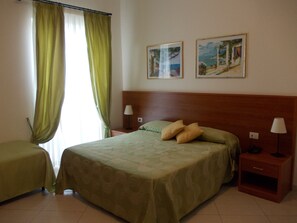 Standard Triple Room | Minibar, in-room safe, desk, blackout drapes