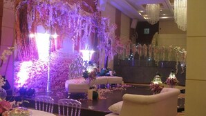 A banquet hall with a stage, seating, and floral decorations. - Al Hayatt Jeddah Hotel (Jeddah)