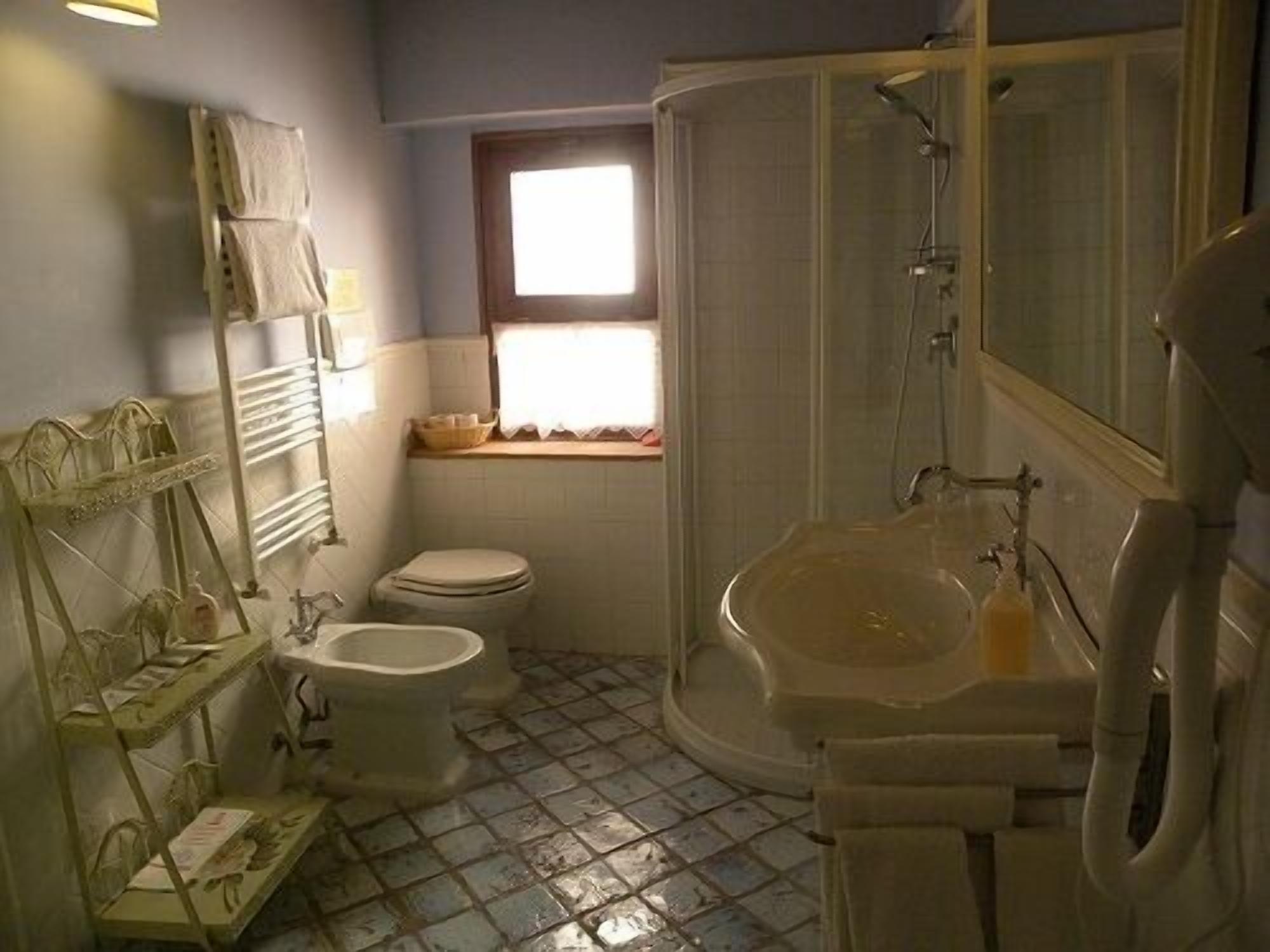 A bathroom with a toilet, a sink, and a shower.