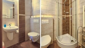 A bathroom with a sink, toilet, and glass-enclosed shower. - VISITzakopane City Apartments (Zakopane)