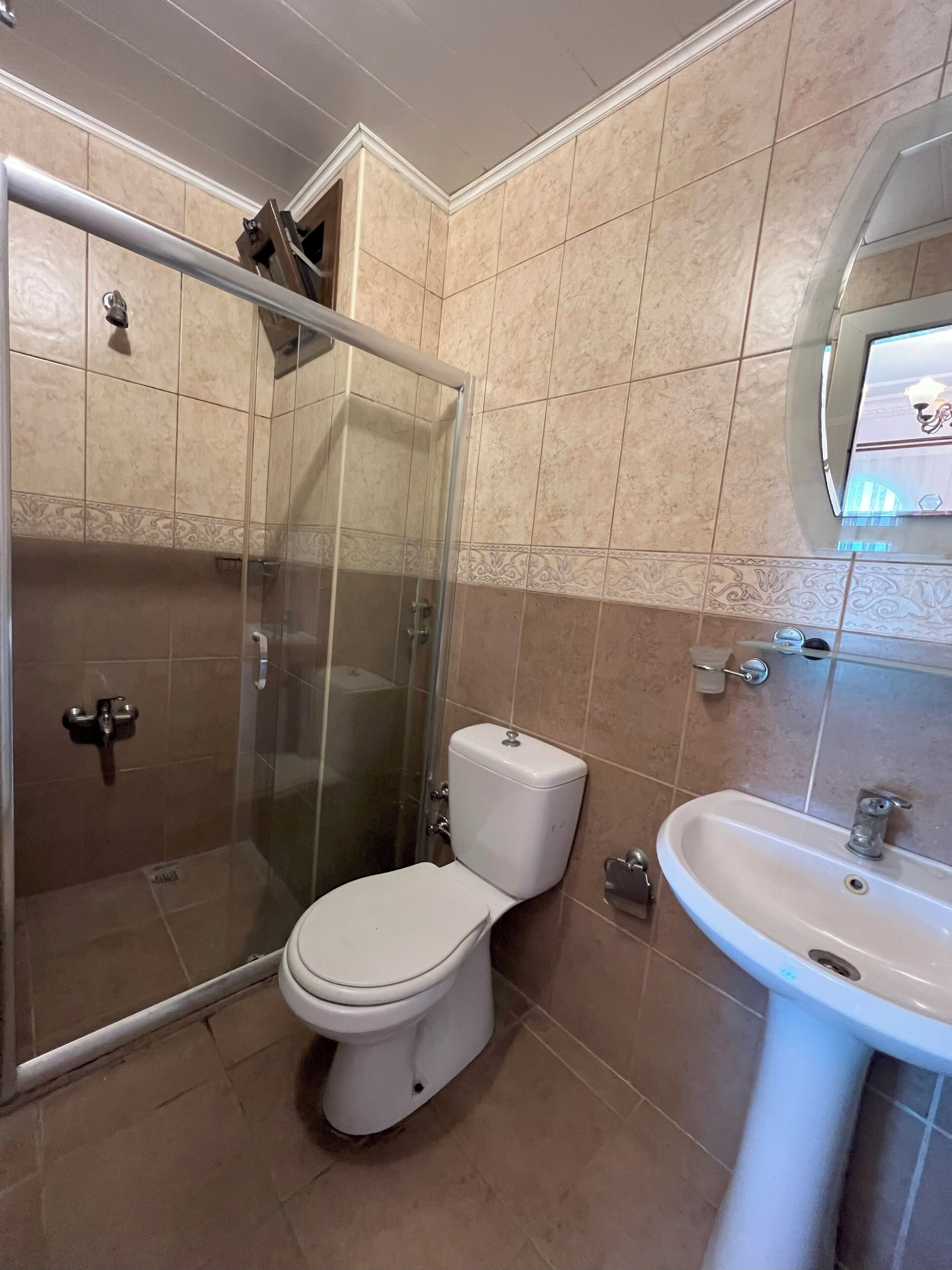 shower, hair dryer, slippers, towels