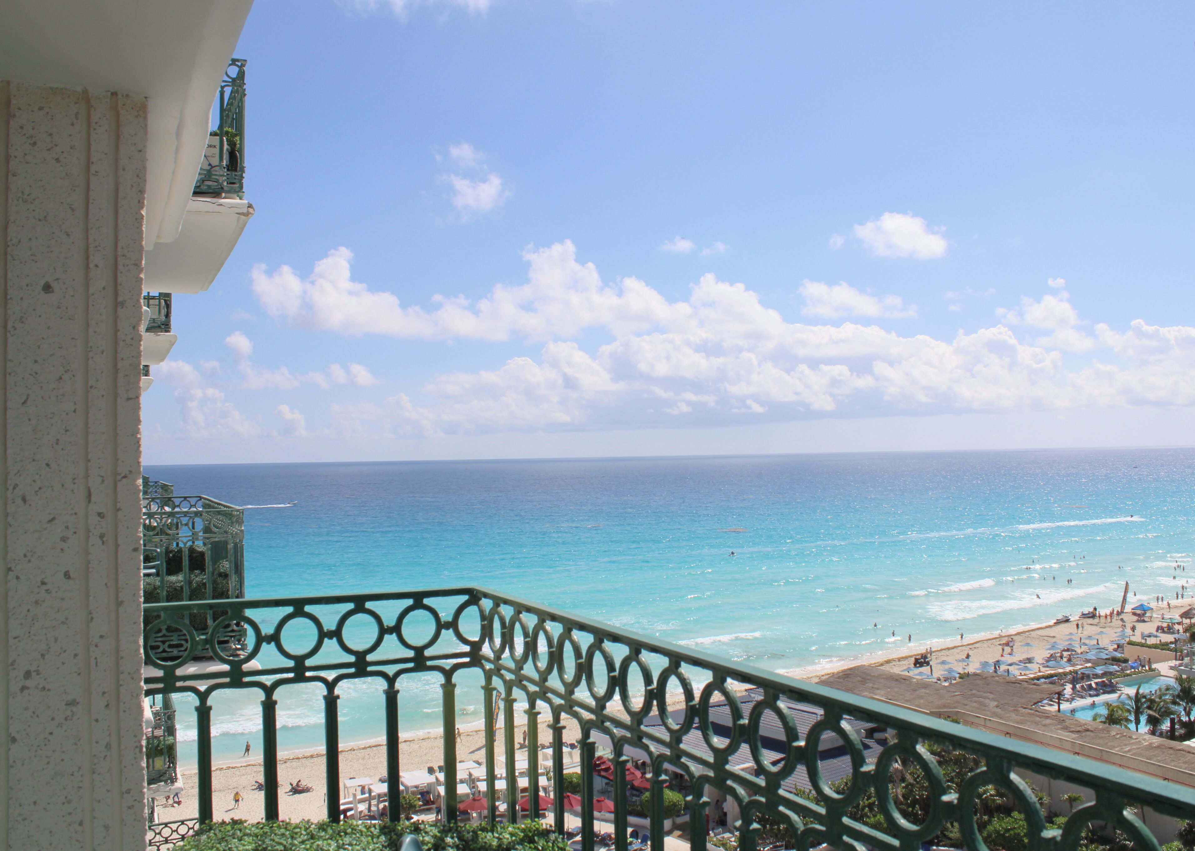 A balcony with a view of a beach and ocean.