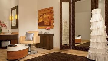 Relax in a stylish space with a comfortable seating area, large mirror, and wall art.