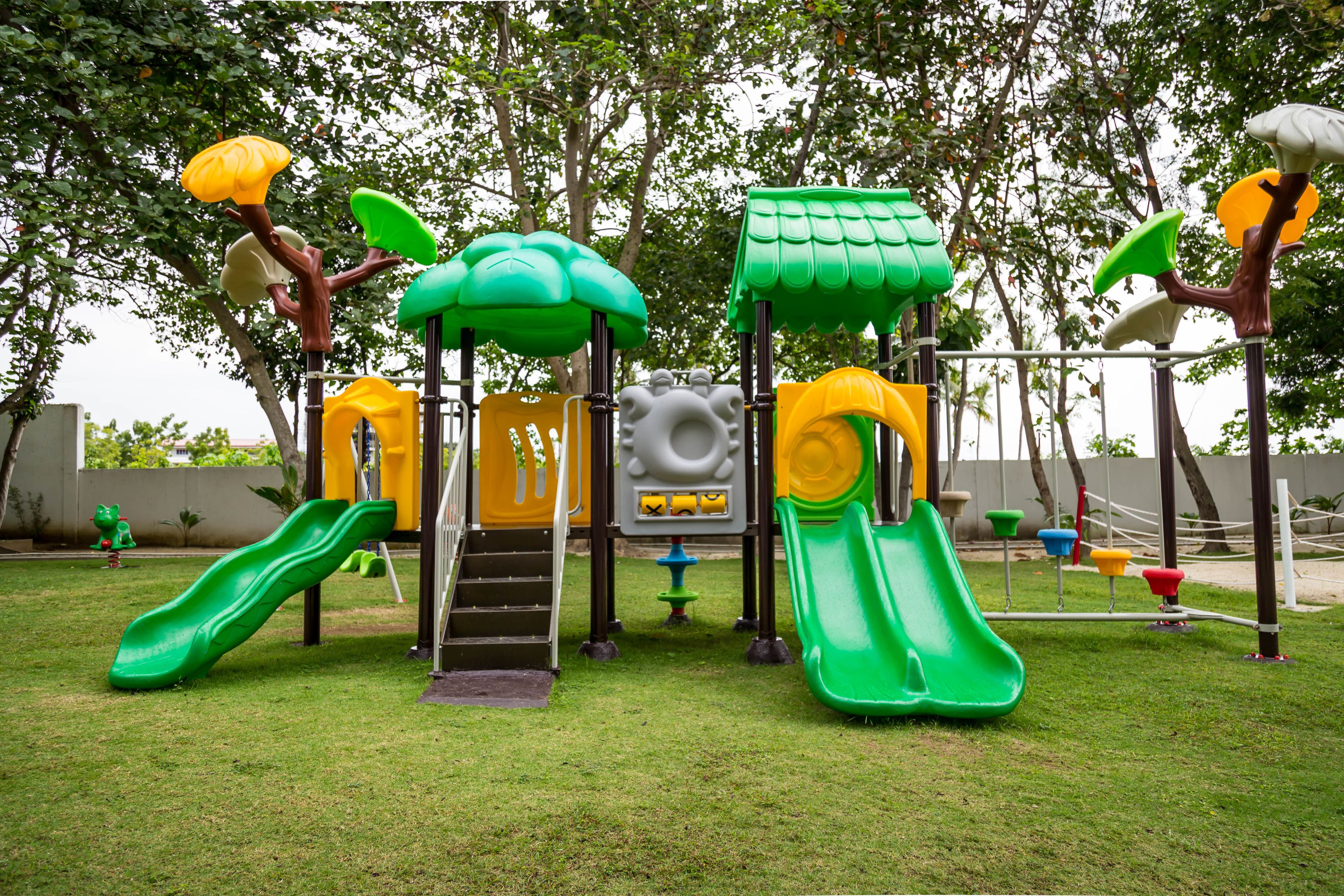 A playground with multiple slides and climbing structures.
