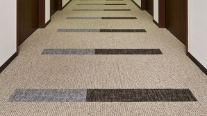 A hotel hallway with carpeted floors, wooden doors, and a long corridor leading to a bright end. - Daiwa Roynet Hotel Sakaihigashi (Sakai)