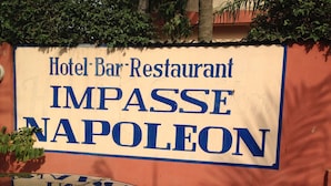 A sign for a hotel bar-restaurant named IMPASSE NAPOLEON. - Napoléon Aéroport (Lomé)