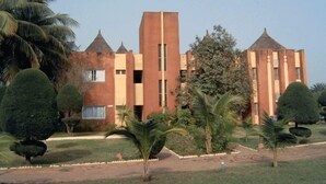 A building with a symmetrical facade, multiple windows, and a central tower.