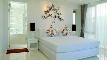 A modern bedroom with a large bed, white walls, a decorative wall piece, and a view of the outdoors through a window.