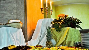 A buffet table with various dishes, a pineapple centerpiece, and a candelabra with candles. - Hotel BM International (Sarajevo)