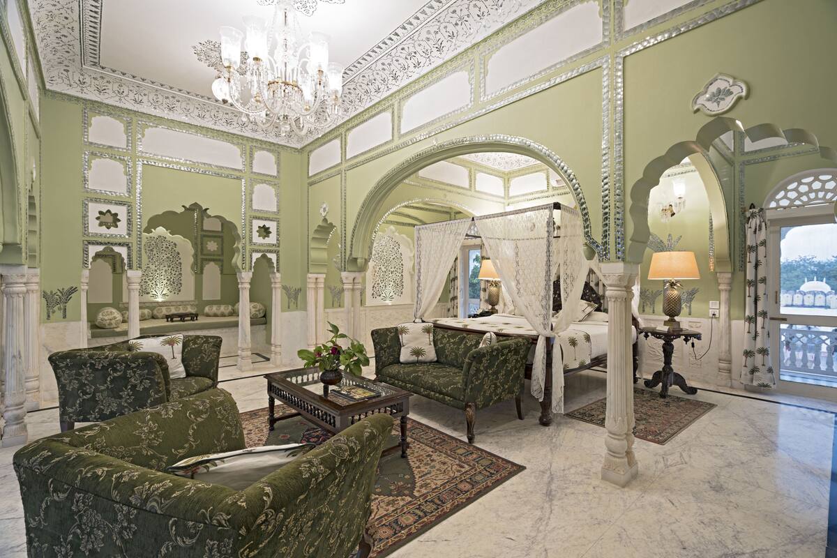 A luxurious room with ornate arches, a canopy bed, and traditional furnishings.