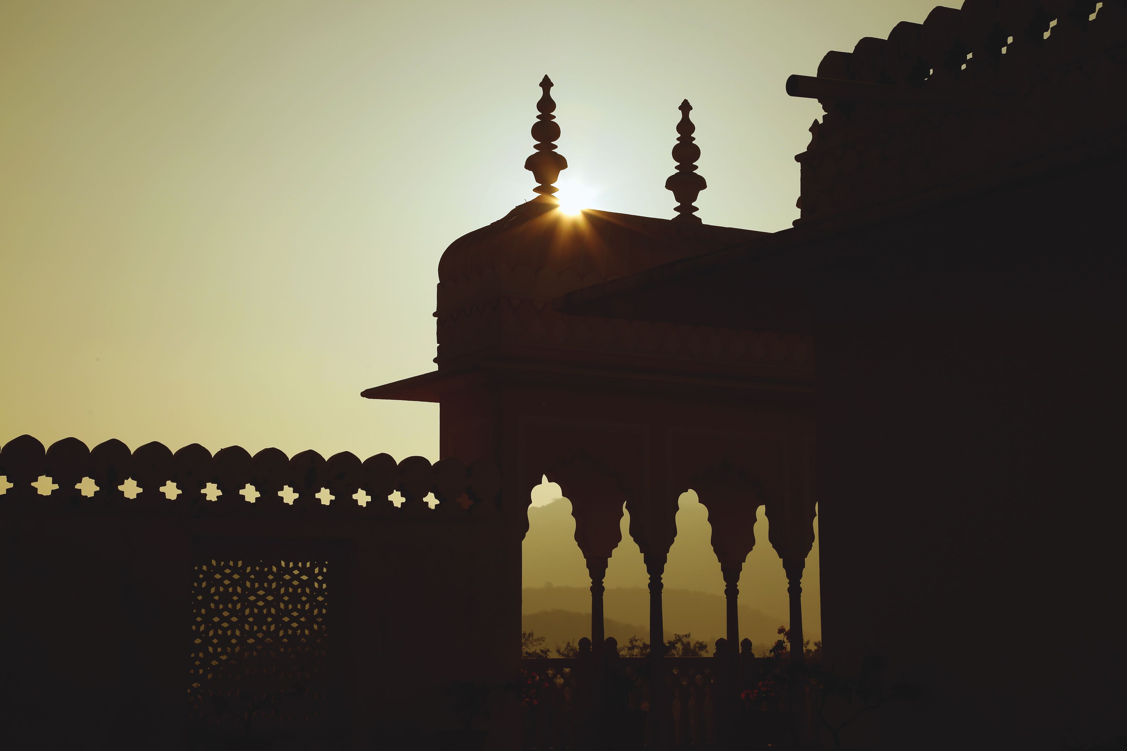 A silhouette of a building with a dome and arches, likely a historical or cultural site.