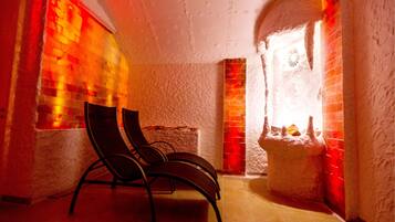 Relax in a cozy seating area with a brick wall and window, featuring a comfortable spot to unwind.