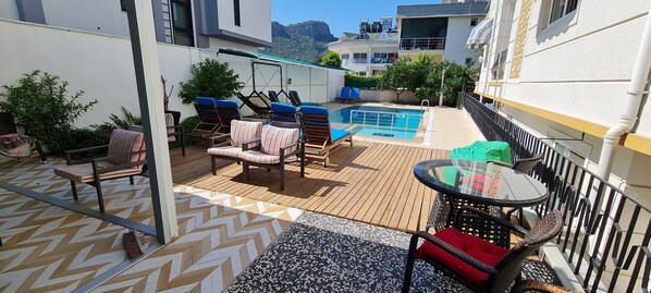 Seasonal outdoor pool, pool umbrellas, pool loungers